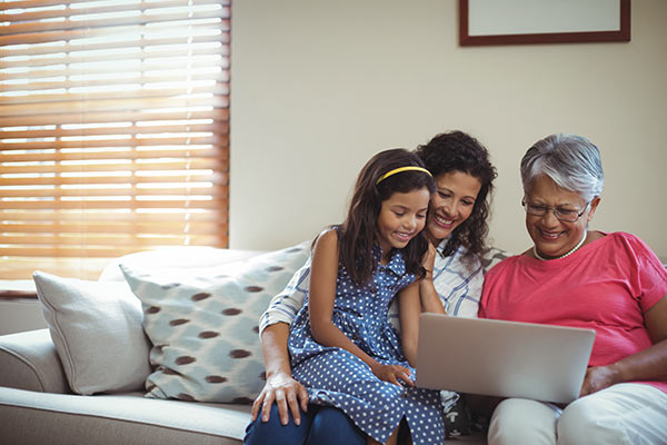 Woman sitting on the couch with her daughter and her mother